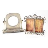 A George V hallmarked silver picture frame in the form of a swing dressing table mirror,