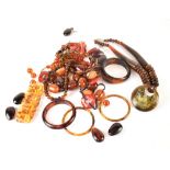 A quantity of amber-coloured jewellery to include necklaces, bangles, etc.