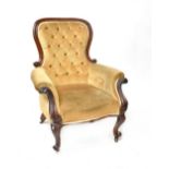 A Victorian mahogany spoon-back armchair.