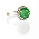 An 18ct white gold emerald and diamond ring,