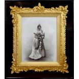 A Victorian black and white photograph of a bride holding flower bouquet,