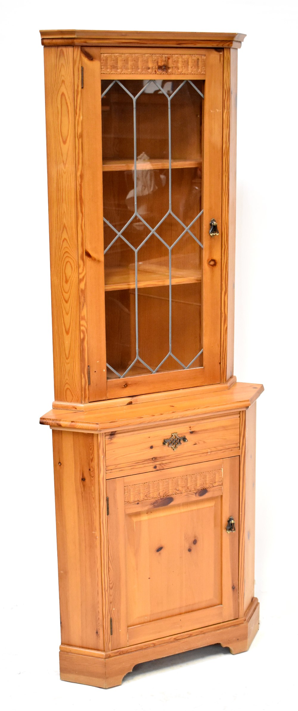 A pine freestanding corner cupboard with glazed upper section above panel door, height 184cm.