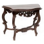 A reproduction hardwood console table, serpentine top on C-scroll and heavily carved base,