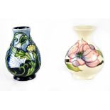 A Moorcroft Pottery 'Magnolia' pattern cream ground baluster-shaped vase, impressed marks to base,