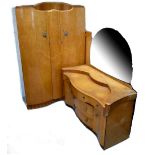 An early 20th century bird's-eye maple bedroom suite comprising double bow-fronted wardrobe,