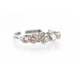 An 18ct white gold ring set with five graduated brilliant-cut diamonds in claw settings,