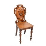 A 19th century oak shield-back hall chair.