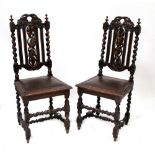 A pair of 19th century oak carved dining chairs, back rail carved with oak leaves,