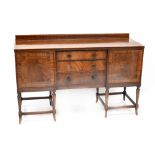 An Edwardian inlaid mahogany sideboard with ebonised decoration to the frieze above three central