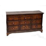 A Georgian oak mule chest, the front with faux cross-banded drawers,