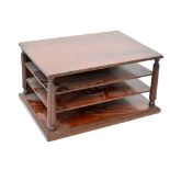 A 19th century mahogany three-tier desk letter tray on reeded columns and platform base, width 42cm,