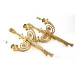 A pair of gilt metal twin-branch wall sconces in the form of tasselled drapery and plaited twists,