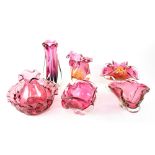 A group of seven cranberry and cranberry-style glass items to include cranberry glass jug (af),