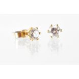 A pair of diamond stud earrings, each approx 0.3ct, set in yellow metal.