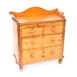 An early 20th century pine stained two-over-two chest of drawers,