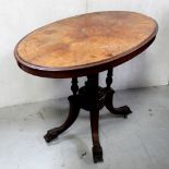 A 19th century walnut inlaid oval table, to four columns and outswept support, length 95cm.