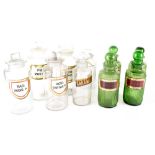 Ten various glass apothecary jars, four green with ribbed bodies,