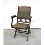 An upholstered mahogany folding chair with turned decoration to back.