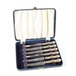 A cased set of George VI hallmarked silver handled fruit knives with reeded shell motif handles,