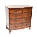 A Victorian mahogany bow-front two-over-three chest of drawers to turned baluster supports,