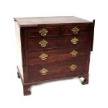A George III oak chest of two short and three long drawers with brass drop handles,