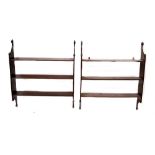 A pair of 19th century style mahogany three-tier wall-hanging shelves with carved roundel