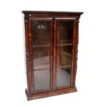 A Victorian rosewood glazed floorstanding bookcase with reeded and acanthus carved pilasters on an