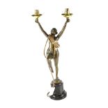 A modern Art Deco style bronze table lamp in the form of a stylised dancer holding two lights,