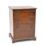 A small 19th century mahogany chest of four long drawers with brush-in slide,