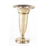 A George V hallmarked silver trumpet vase with flared rim, raised on a circular foot, loaded base,