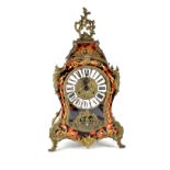 A reproduction brass-mounted bombé-shaped boule type mantel clock,
