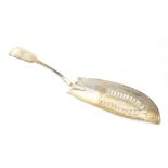 A George III hallmarked silver fiddle pattern fish slice with engraved crest,