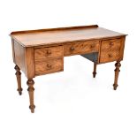 An Edwardian mahogany kneehole desk, one central frieze drawer with two drawers to either side,