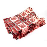 A Welsh woven wool traditional blanket, cream, red and black design.