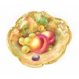 A Royal Worcester pin dish hand painted with fruit within a gilt C-scroll border,