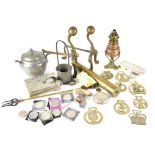 A quantity of mixed metalware to include brass fire dogs, horse brasses,