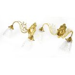Four twin-branch gilt metal wall lights with pierced scrolling decoration and shell motifs,