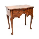 An 18th century style walnut lowboy with bow front, with three drawers, on carved cabriole legs,