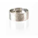 An 18ct white gold ring with crosshatch textured decoration, size P, approx 7.7g.