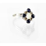 A 9ct white gold opal, diamond and sapphire cluster ring, size N, approx 2.4g.