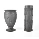 Two Wedgwood black basalt vases in the Classical style with raised figural and swag decoration,