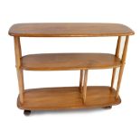 ERCOL; a medium elm three tier bookcase trolley, height 71cm, length 91cm, depth 31.5cm.Additional