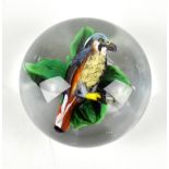 RICK AYOTTE; a glass paperweight encased with a bird perching in floral setting, signed, no.M-95 and