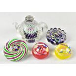 JOHN DEACONS; five contemporary glass paperweights including an example with internal swirling
