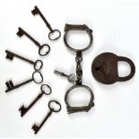 A pair of 19th century hand cuffs complete with key, inscribed 'Hiatt 14', also similarly stamped to