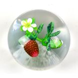 KEN ROSENFELD; a clear glass paperweight encased with strawberries, signed and dated ‘99 to rim,