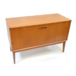 A mid-century teak record cabinet with fall-front enclosing five divides raised on tapering block