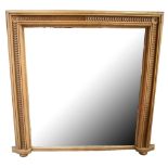 A pine overmantel mirror with moulded border set with overlapping round handles, width 134cm, height