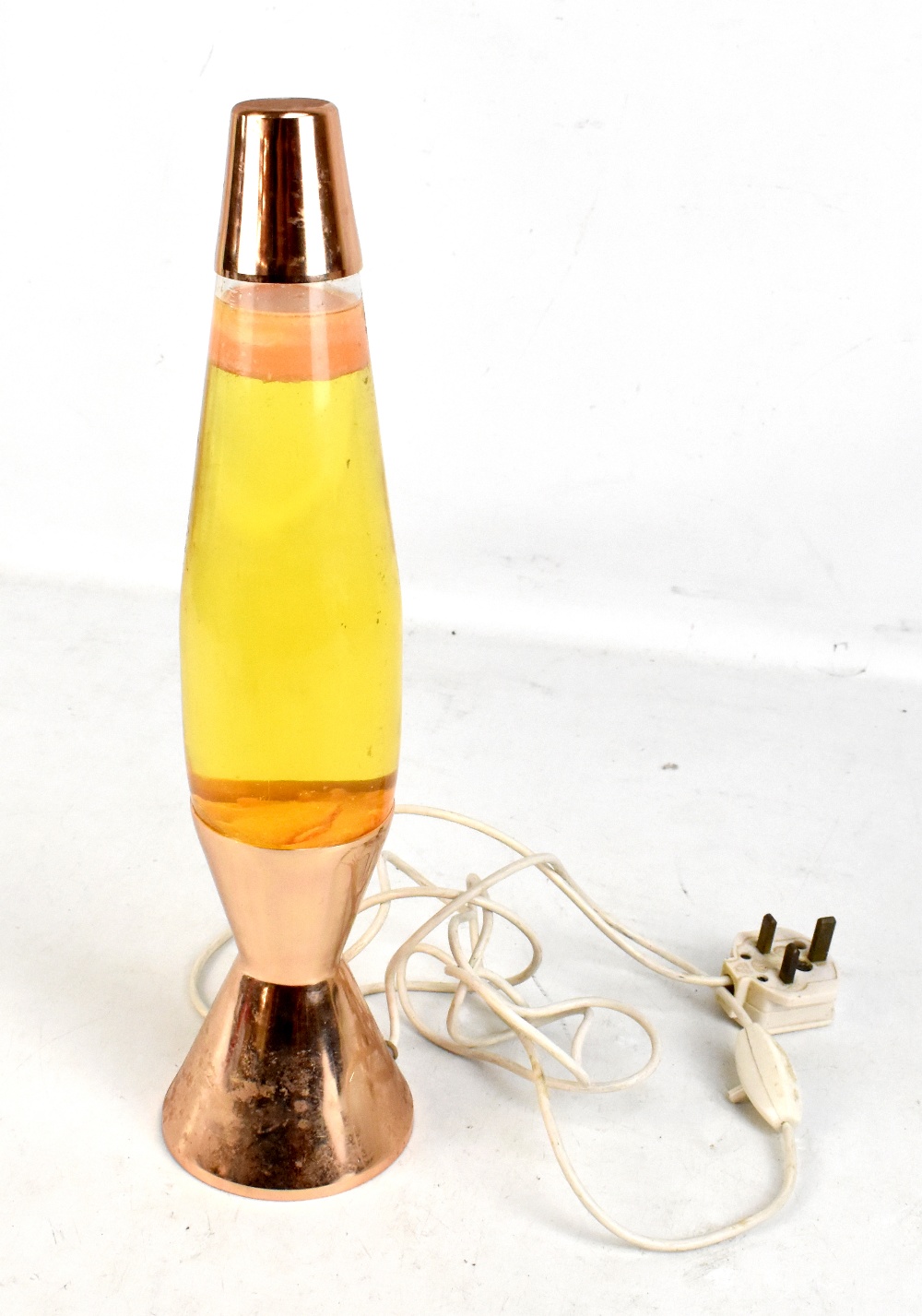An original early 1970s lava lamp with copper coloured finished, height 40.5cm. Please note this
