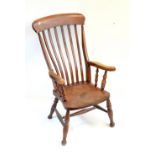 A late 19th century beech and elm bar back kitchen Windsor chair with swept arms, saddle seat and